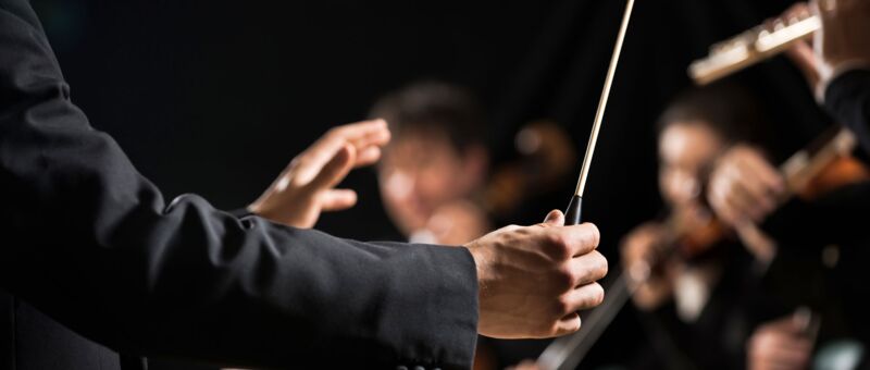 conductor's hand with a baton